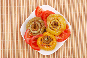 Stuffed paprika and tomato on a plate