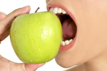 Apple macro on woman mouth detail of bite