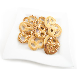 Knot-shaped biscuit with sugar and sesame