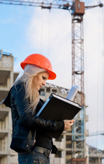 young girl in a helmet before building