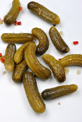 some sour gherkins and a white background