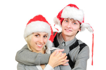 Happy couple in santa's hats isolated on white