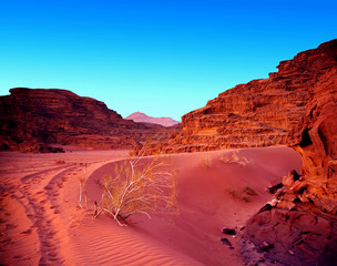 Sunset in desert with sand and mountain. Landscape.