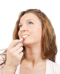 girl applying lipstick over white