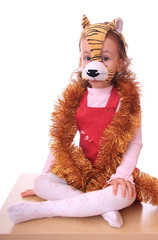 Little girl is in the mask of tiger.