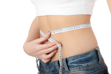 Sexy, fit, young woman measuring