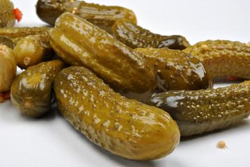 some organic sour gherkin and a white background