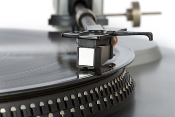 Fototapeta na wymiar Stylish 20-years old turntable with vinyl record having