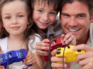 Obraz premium Happy father and his children playing video games