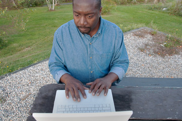 African American Man Outdoors With Laptop