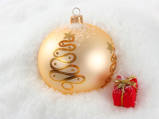 Christmas decorating bulbs and present in the snow.