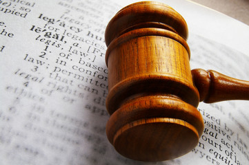 closeup of a gavel and dictionary legal definition