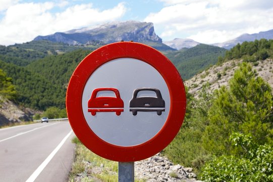 Nostalgic No Overtaking Traffic Sign Showing Two Old Cars