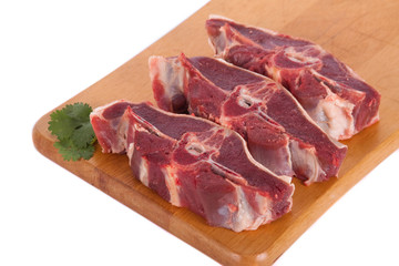 Fresh mutton on wooden board with parsley