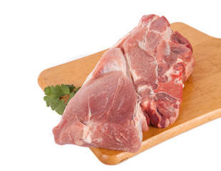 Fresh pork meat on wooden board with parsley