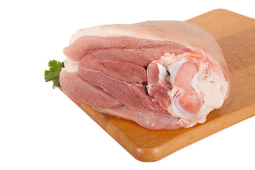 Fresh pork meat on wooden board with parsley