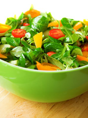 Fresh vegetable salad served in a green salad bowl