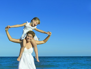 Fototapeta na wymiar woman and girl on the beach