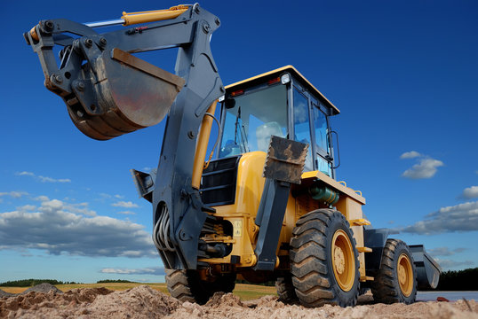 rear view of  Loader excavator with rised backhoe