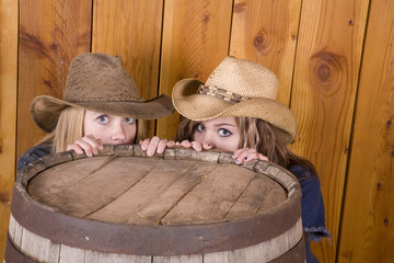 girls hiding behind barrel