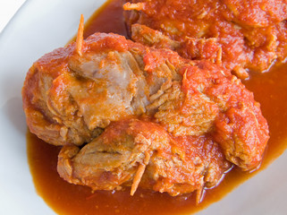 Meat roulade with tomato sauce on plate