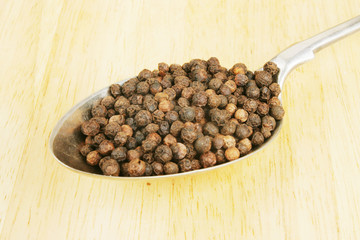Pepper corns in a spoon