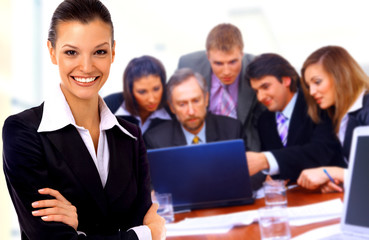 Obraz na płótnie Canvas Smiley businesswoman with a group behind him.