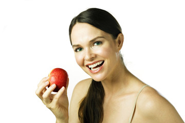 Young happy beautiful woman eating an apple