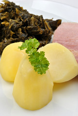 smoked gammon joint with organic potato on a plate