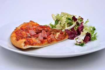 italian pizza with ham, salami and salad