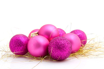 Lots of pink christmas balls over white background