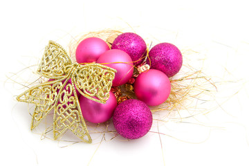 Pink christmas balls with golden ribbon over white background