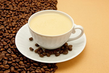 White cup of coffee and coffee beans