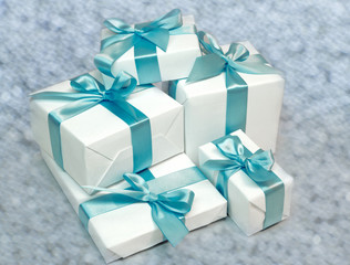 Cute white gift boxes with blue ribbon