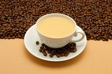 White cup of coffee and coffee beans