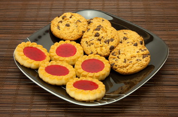 plate of cookies on dark brown background