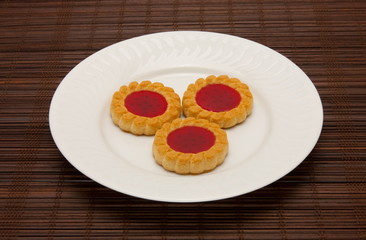 plate of cookies on dark brown background