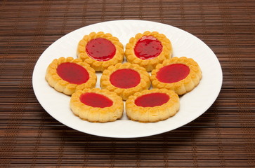 plate of cookies on dark brown background