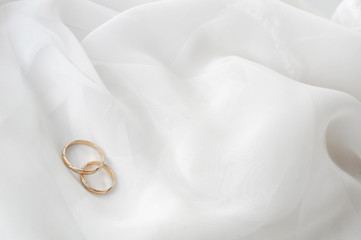 White  fabric and wedding rings