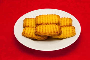 plate of cookies on red background