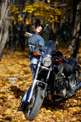 Obraz na płótnie Canvas The brunette girl about a motorcycle