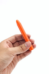 Hand Holds Orange Crayon