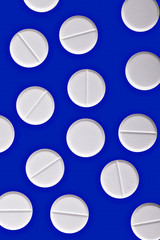 white pills on blue