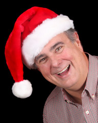 Older man wearing a smile and a Santa hat - 18882642