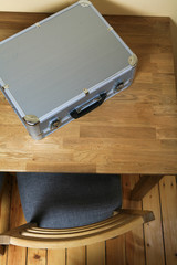 Aluminum suitcase on table