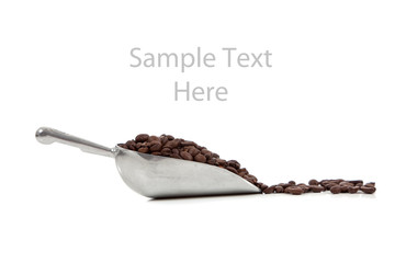 Fototapeta premium A silver scoop with coffee beans on white