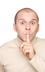 Man holding finger on lips