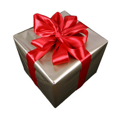 Gift in golden wrapping with red bow isolated on white