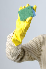 human hand with sponge and yellow glove