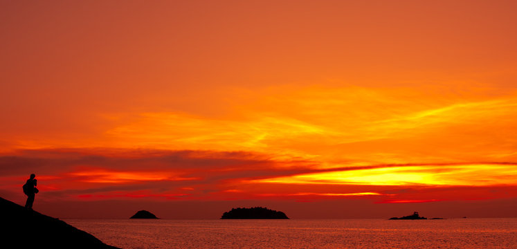 Man stay on hill on sunset